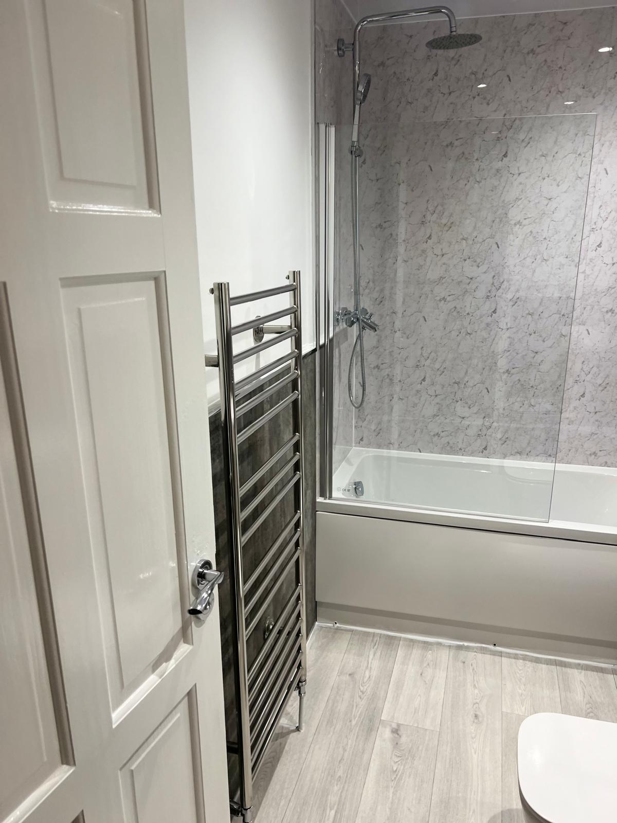 Completed family bathroom with bath and rainfall shower