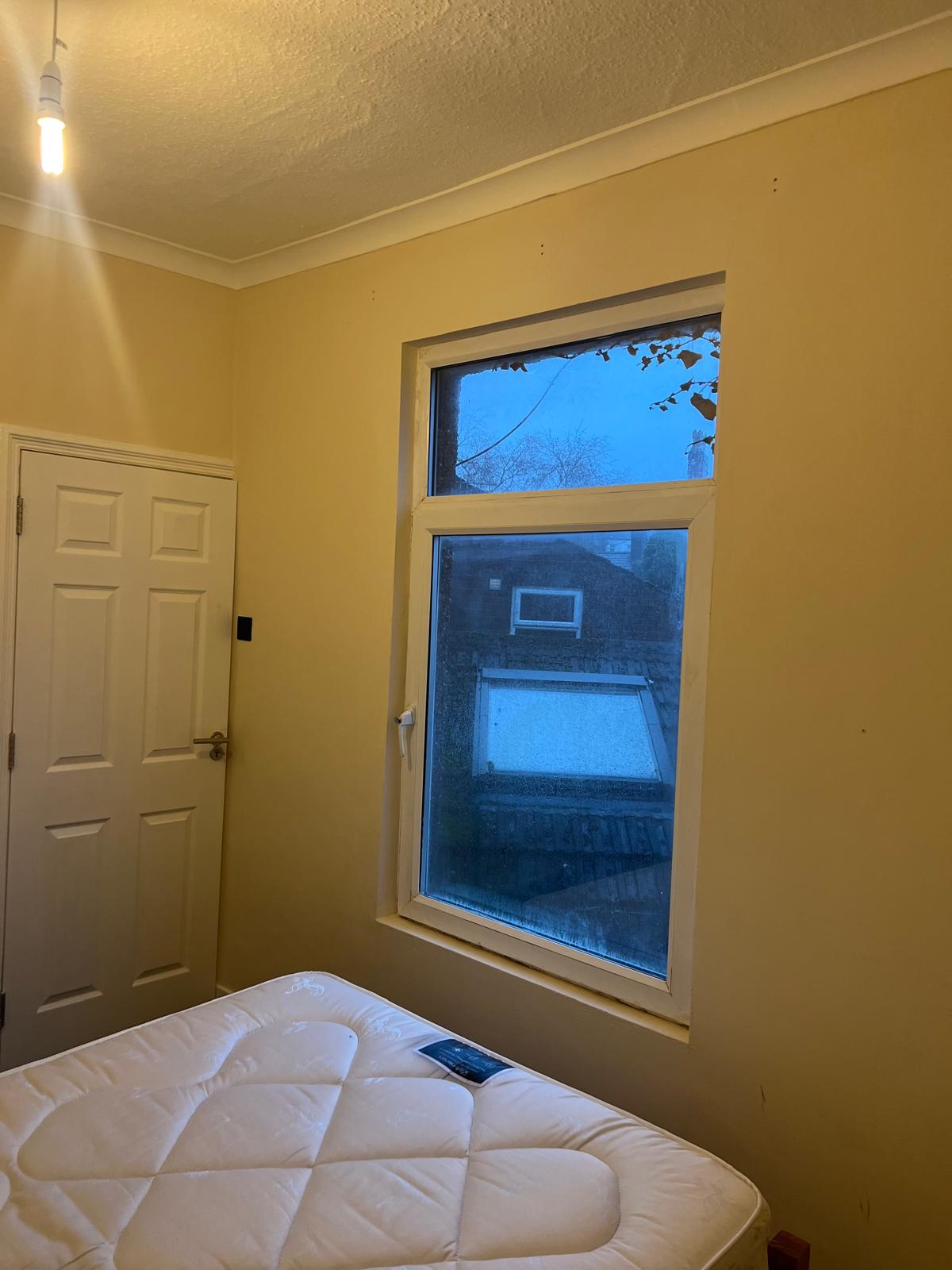 Finished bedroom with a large window
