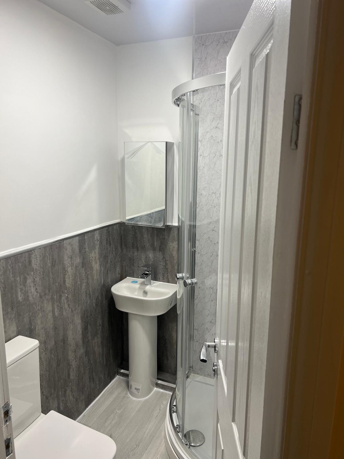 New compact shower room with modern grey finishes